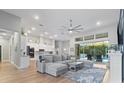 Spacious living room features a plush sectional sofa and a view of the pool at 16697 Courtyard Loop, Land O Lakes, FL 34638