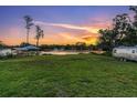The grassy backyard with waterfront access is perfect for relaxation and recreation at 18102 Spencer Rd, Odessa, FL 33556