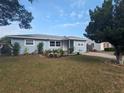 Beautiful light blue single-story house with a manicured lawn and a decorative flower bed in the front yard at 2004 Culberson Ave, Dunedin, FL 34698