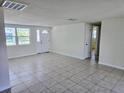 Bright living room featuring tile floors, a ceiling fan, and neutral paint, creating a welcoming atmosphere at 2051 Peggy Dr, Holiday, FL 34690