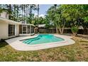 Inviting backyard featuring a pristine pool and screened-in lanai, perfect for outdoor enjoyment at 22154 Weeks Blvd, Land O Lakes, FL 34639