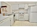 Functional kitchen with standard appliances and ample cabinet space at 2836 Featherstone # 2836, Holiday, FL 34691