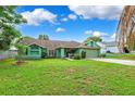 Single-story home featuring lush lawn, a concrete driveway, and an attached two-car garage at 3468 El Prado Ave, Spring Hill, FL 34609