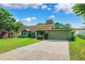 Single-story home featuring lush lawn, a concrete driveway, and an attached two-car garage at 3468 El Prado Ave, Spring Hill, FL 34609