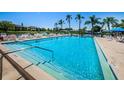 Large community swimming pool and lounging area overlooking lake, perfect for relaxation and socializing at 3838 Lanyard Ct # 3838, New Port Richey, FL 34652