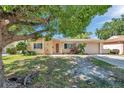 Quaint single-story home with a well-manicured front yard and an inviting entrance at 4025 Stratfield Dr, New Port Richey, FL 34652