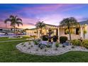 Charming home featuring well-manicured landscaping, a decorative fountain, and lush green lawn at 4387 6Th Isle Dr, Hernando Beach, FL 34607