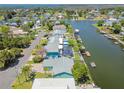 Aerial view of waterfront homes lining a canal, complete with private docks and lush landscaping at 4482 Kingston Dr, Hernando Beach, FL 34607