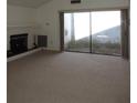 Spacious living room featuring plush carpeting, a fireplace, and sliding glass doors to a patio area at 4529 Keelboat Pl, New Port Richey, FL 34652