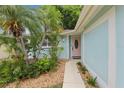 Attractive front entrance with a landscaped walkway leading to a pastel-colored door at 4942 Blue Heron Dr, New Port Richey, FL 34652