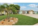 Inviting home exterior with lush green lawn and attractive landscaping features at 4942 Blue Heron Dr, New Port Richey, FL 34652