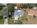 An aerial view of the property showcasing the pool, backyard, landscaping, and surrounding neighborhood at 5309 Bayonne Ave, Spring Hill, FL 34608