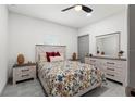 Comfortable bedroom with a decorative bedspread, coordinating nightstands, and a spacious dresser with a mirror at 5328 Baldock Ave, Spring Hill, FL 34608