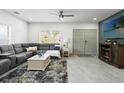 Bright living room features a plush gray sofa, stylish rug, and double doors, creating a cozy atmosphere at 5328 Baldock Ave, Spring Hill, FL 34608