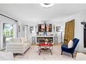 Comfortable living room with neutral decor, tile flooring, and sliding door access to the patio at 5340 Pilots Pl, New Port Richey, FL 34652