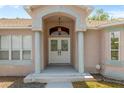 Close-up of the grand entrance featuring double doors and decorative columns at 8382 Christopher Ln, Weeki Wachee, FL 34613