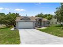 Inviting single-story home with a spacious driveway and a well-maintained lawn at 8382 Christopher Ln, Weeki Wachee, FL 34613