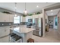 Lovely kitchen with stainless steel appliances, subway tile backsplash, a center island with seating, and plenty of cabinetry at 8431 Ocean Tides Cv, Parrish, FL 34219