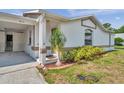 Charming single-story home with a well-manicured lawn, bright exterior paint and a two-car carport at 9212 Estrada Pl, New Port Richey, FL 34655