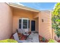 Inviting front entrance with cozy seating area and charming architectural details at 9334 Whitstone Ct, New Port Richey, FL 34655