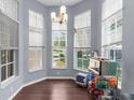 Bright dining area featuring large windows and contemporary lighting with a view to the outdoors at 9407 Burnam Dr, Weeki Wachee, FL 34613