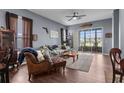 Cozy living room featuring stylish furniture, a ceiling fan, and sliding glass doors leading to the porch at 9407 Burnam Dr, Weeki Wachee, FL 34613