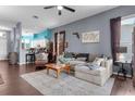 Spacious living room with an open layout, hardwood floors, and comfortable seating arrangement at 9407 Burnam Dr, Weeki Wachee, FL 34613