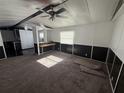 The living room has a ceiling fan, a window, and a partial view of the kitchen at 9444 Loras St, New Port Richey, FL 34654