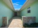 Inviting entryway with stone accents, brick pavers, and a skylight at 9810 San Sebastian Way, Port Richey, FL 34668