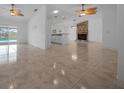 Open living room with tile floors, ceiling fans, and fireplace at 9810 San Sebastian Way, Port Richey, FL 34668