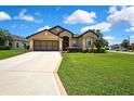 Lovely single Gathering home featuring a spacious front yard with lush green grass and mature landscaping at 10155 Duffy Cir, Weeki Wachee, FL 34613