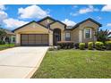 Well maintained one story home with two-car garage, manicured lawn, and mature shrubbery at 10155 Duffy Cir, Weeki Wachee, FL 34613