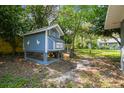 Backyard showing chicken coop and surrounding trees at 10301 Nina Ct, New Port Richey, FL 34654