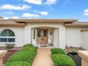 Close-up of the home's inviting front entrance with a meticulously maintained garden and water feature at 10442 Ventura Dr, Spring Hill, FL 34608