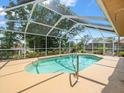 Inviting screened-in pool area perfect for relaxation and outdoor entertainment in a backyard at 10442 Ventura Dr, Spring Hill, FL 34608