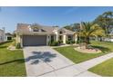 Inviting one-story home with a manicured lawn, mature landscaping, and a convenient two-car garage at 1049 Larkin Rd, Spring Hill, FL 34608