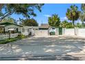 Rear view of home showcasing the parking court and backyard shed with green accents at 1115 Pennsylvania Ave, Palm Harbor, FL 34683