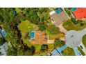Aerial view of the property showcasing the pool, large backyard, and neighborhood at 11291 Countrywood Ct, Spring Hill, FL 34609