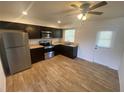 Bright kitchen featuring stainless steel appliances, ample counter space, and wood-look flooring at 11392 Beechdale Ave, Spring Hill, FL 34608