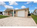 The single-story home features a brick exterior, attached garage, and a paved driveway at 12637 2Nd Isle, Hudson, FL 34667