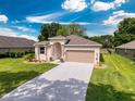 Beautiful single-story house boasting a well-manicured lawn and an attached two-car garage at 13349 Niti Dr, Hudson, FL 34669