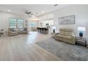 Bright living room with hard wood floors and open to the dining and kitchen area at 13349 Niti Dr, Hudson, FL 34669