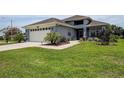 Charming single-story home with a well-manicured lawn, two-car garage and beautiful landscaping at 14011 Shoal Dr, Hudson, FL 34667