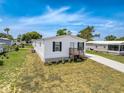 Charming single-story home featuring a covered carport and a well-maintained lawn at 16037 Brookridge Blvd, Brooksville, FL 34613