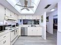 Bright kitchen with stainless steel appliances, light wood cabinets, and modern flooring at 2139 Sea Pines Ct, Spring Hill, FL 34606