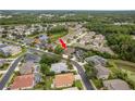 An aerial view shows this home is nestled in a serene community with lush landscaping and nearby water features at 2526 Brinley Dr, Trinity, FL 34655