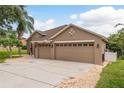 Charming single-story home showcasing a spacious driveway and a two-car garage at 2526 Brinley Dr, Trinity, FL 34655