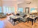 Elegant living room with comfortable seating, large windows, and mirrored wall accents at 3627 Muirfield Ct # 3627, New Port Richey, FL 34655