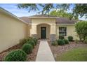 Inviting home entrance with decorative stone accents and manicured shrubs at 3631 Celebration Dr, Brooksville, FL 34604