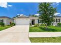 Inviting single-Gathering home with a well-kept lawn and mature tree, offering a serene and welcoming curb appeal at 3886 Reflection Dock Dr, Seffner, FL 33584